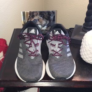 Adidas work out shoes grey, white, and pink.